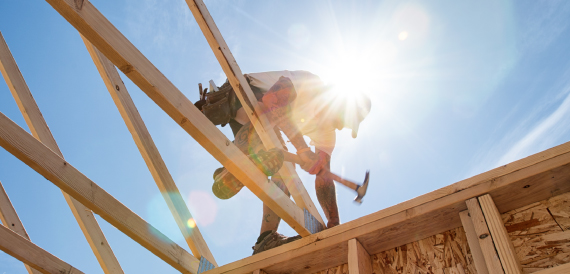 construction worker on roof building house