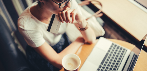 woman sitting at laptop with coffee